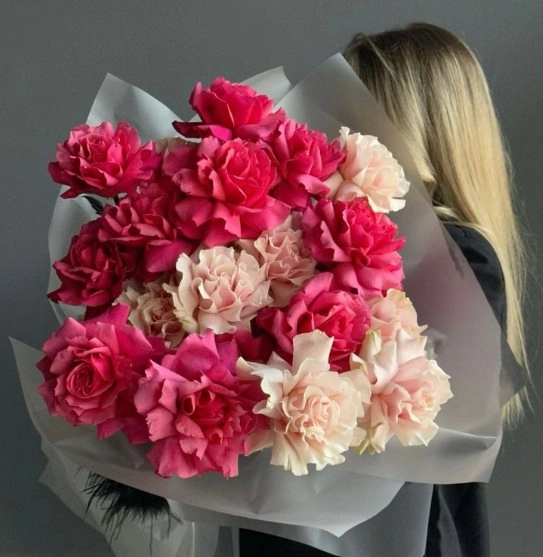 žena drží kyticu francúzskych ruží